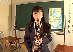 Playful student chick blows the pipe in the college room