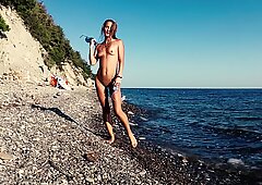 Travel slut teases a videographer and fucks him on the beach